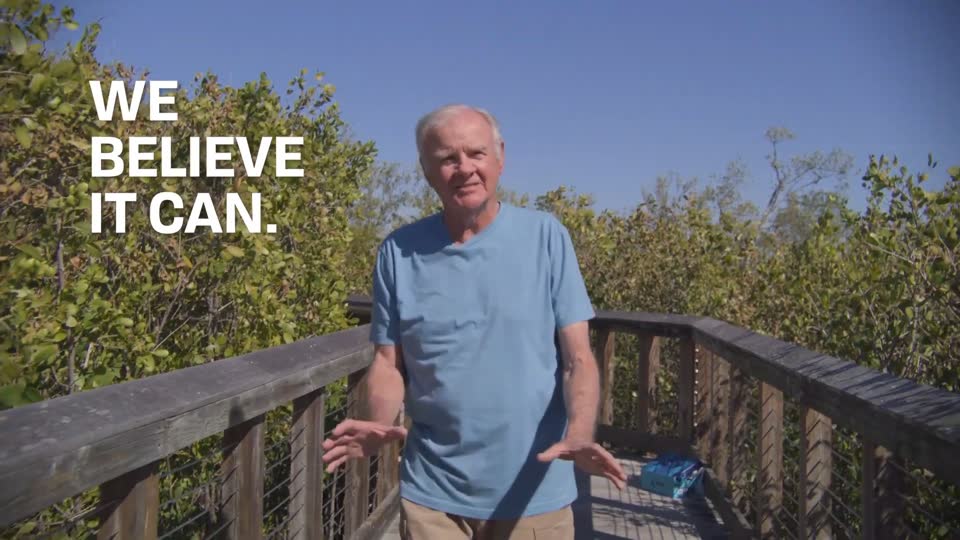 Man on a boardwalk with burned-in caption