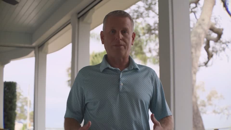 Man walking toward camera on a porch